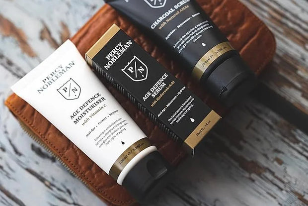 Age Defence Kit, a men's skincare set containing Charcoal Face Scrub (with Natural AHAs), ultra-hydrating Facial Serum (wi...